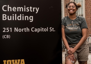 Diamond Jones stands outside of the Department of Chemistry building on the University of Iowa campus